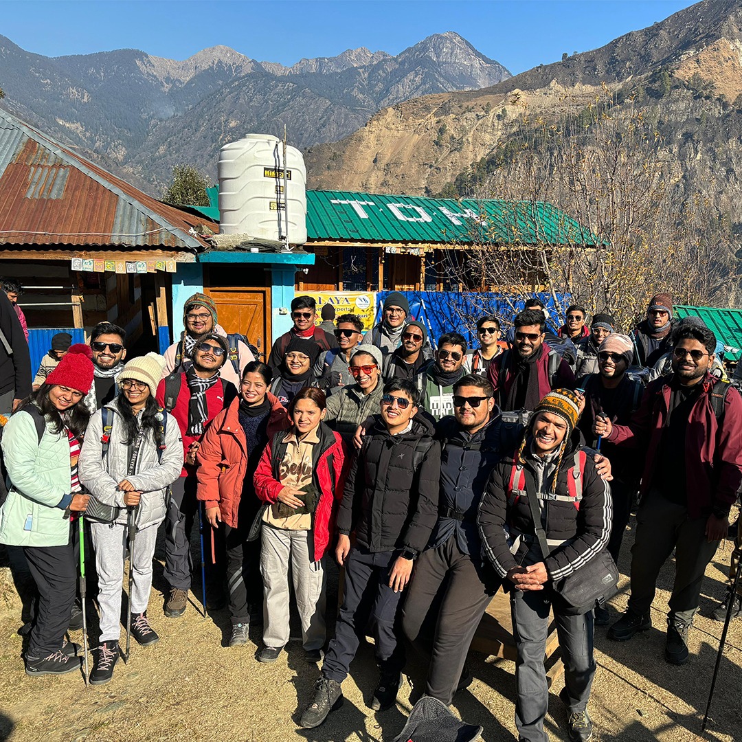 Scenic view of Sankri Base Camp surrounded by lush greenery and Himalayan peaks