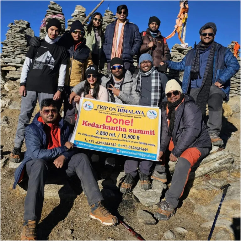 Group of trekkers navigating the snow-covered Kedarkantha Trek trail.