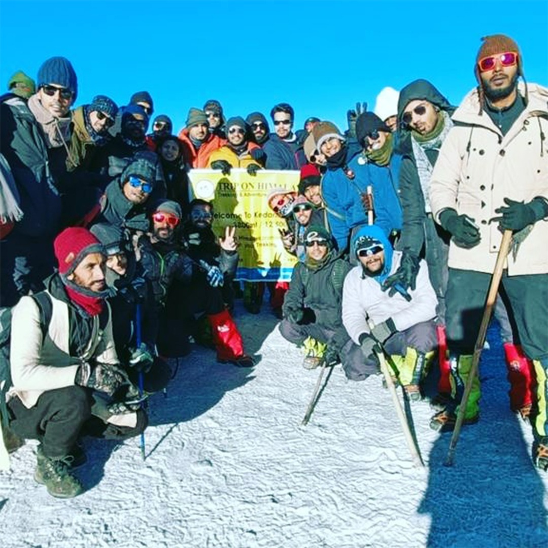 Corporate banner displayed by a group of professionals at Kedarkantha Summit